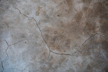 Close up look of rustic cracking cement wall with stains.