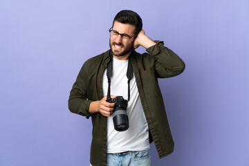 Photographer man over isolated purple background frustrated and covering ears