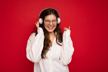 Photo of beautiful happy smiling young brunette woman wearing white shirt and optical glasses...