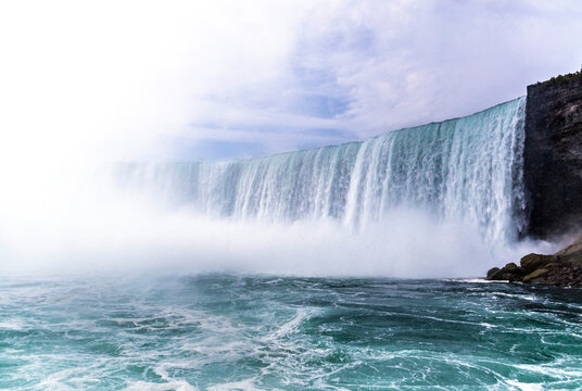 dramatic and spectacular image of the Niagara Falls taken during summer.