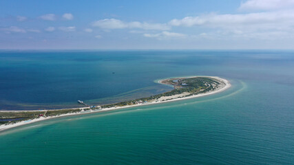 Aerial drone top down photo of seascape of island with sandy beach, turquoise clear waters of black sea in Ukraine and trees on island Dzharilgach.