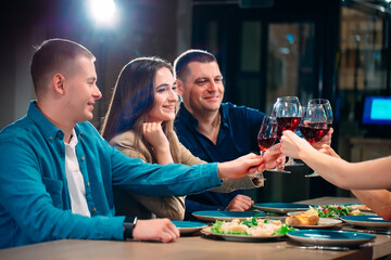 Party at a restaurant. Friends have fun in a restaurant and drink wine. festive mood.