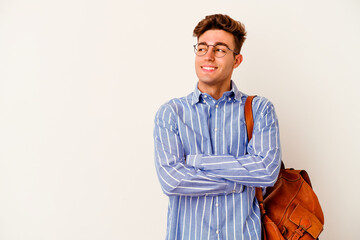 Young student man isolated on white background smiling confident with crossed arms.