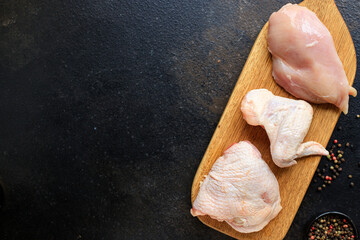 chicken raw meat pieces of poultry carcass breast, thigh, wings snack healthy meal top view copy space for text food background rustic image keto or paleo diet