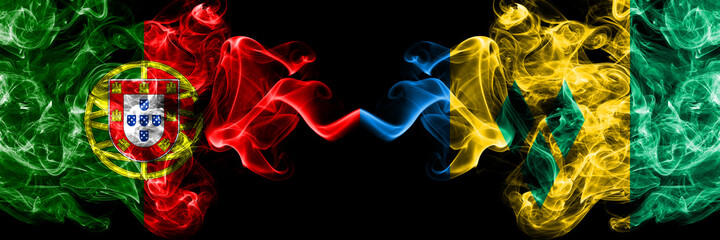 Portugal, Portuguese vs Saint Vincent and the Grenadines smoky mystic flags placed side by side. Thick colored silky abstract smoke flags.
