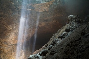 Fototapeta na wymiar Beautiful ray of light inside Jomblang Cave, Yogyakarta, Indonesia