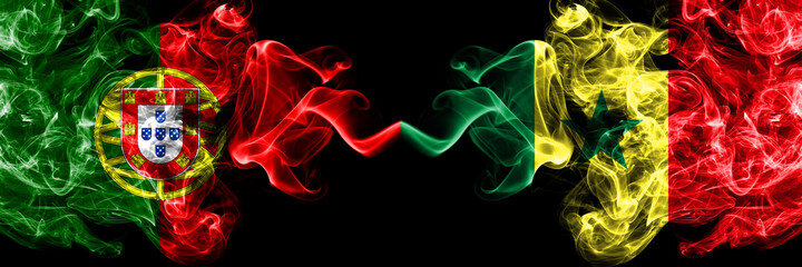 Portugal, Portuguese vs Senegal smoky mystic flags placed side by side. Thick colored silky abstract smoke flags.