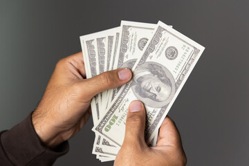 Close up male hand Counting money us dollar. Financial business concept.