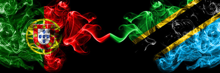 Portugal, Portuguese vs Tanzania smoky mystic flags placed side by side. Thick colored silky abstract smoke flags.