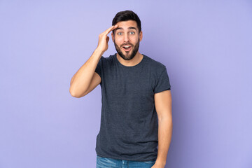 Caucasian handsome man has realized something and intending the solution over isolated purple background