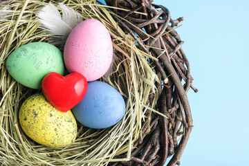 Obraz premium Closeup of red heart and easter egg nest flatlay. Holiday celebration concept. Minimal holiday season concept background.