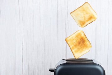 bread toaster jumping on wooden background