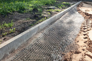 Road surface construction and stabilization using a geogrid.