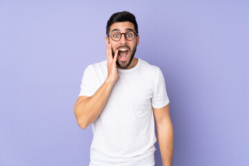 Caucasian handsome man over isolated background with surprise and shocked facial expression
