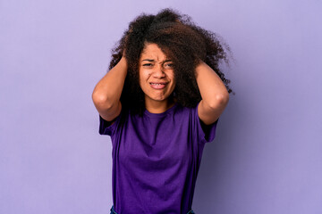 Young african american curly woman isolated on purple background screaming with rage.