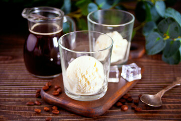 Affogato coffee with ice cream in a glasses on the wooden table