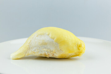 Single Durian on white plate, King of fruit of Thailand.