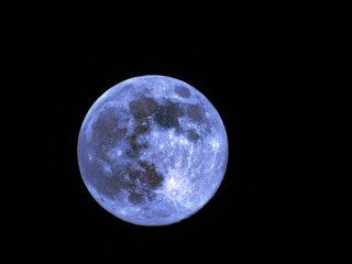 Earth's Moon Glowing with different colours in the Background.
Blue and red moon watched by telescope.