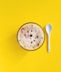 top view of bowl of oatmeal on yellow background, minimal design, healthy breakfast of instant porridge with freeze-dried berries