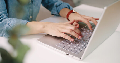 Close up shot of Caucasian female hands working on white modern computer typing and tapping on keyboard sitting at desk in cabinet, woman fingers texting on laptop, digital device, technology concept