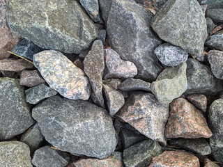 texture and background of colored stones on the river bank in the daytime