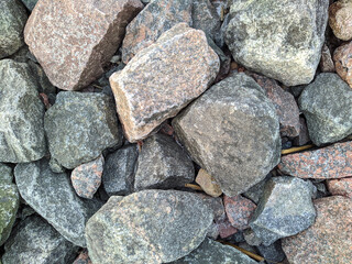 texture and background of colored stones on the river bank in the daytime