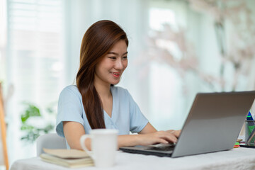 Portrait of beautiful business asian woman working online with laptop at home,Freelance woman working online sale marketing at home,Small Business Startup concept