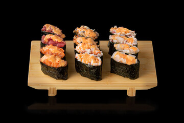 Sushi set. Rolls with salmon eel red caviar and vegetables on black background