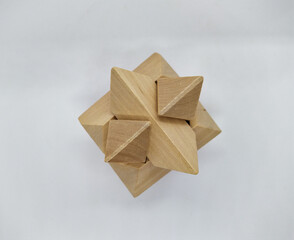 assembled and whole 3d wooden brain teaser on white background