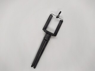 small and black tripod for phone on a white background