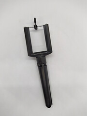 small and black tripod for phone on a white background