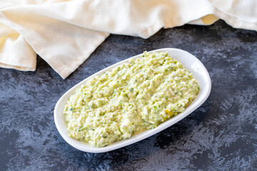 An appetizer prepared with feta cheese and pistachios. Traditional Turkish and Arabic cuisine meze. Snack meal served alongside the main course. Natural vegetarian food. Local name grit ezmesi mezze