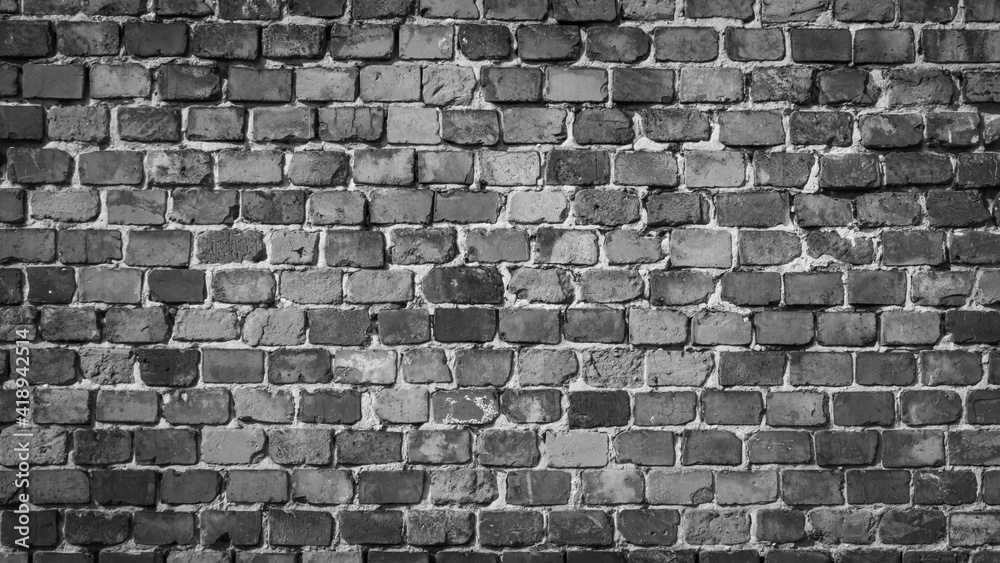 Wall mural gray brick wall with visible texture. background