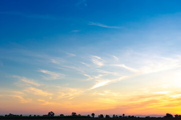 Beautiful Vivid sky painted by the sun leaving bright golden shades.Dense clouds in twilight sky in...