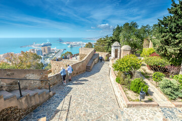 Malaga, Andalucia, Spain - April 16, 2016: people observe the panoramic view of port of Malaga from the Gibralfaro Castle.