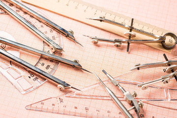 Drawing tools, ruler and protractor on graph paper. Close up