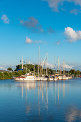 Fototapeta na wymiar Landscape with sailing yachts on the river Harle in Harlesiel