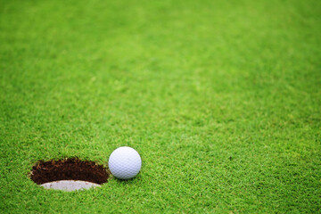 Golf ball close to hole