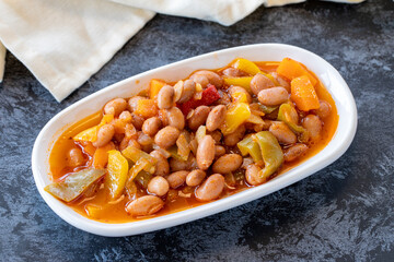 Kidney bean appetizer. Traditional Turkish and Arabic cuisine meze. Snack meal served alongside the main course. Natural vegetarian food. Barbunya plaki. Chili beans