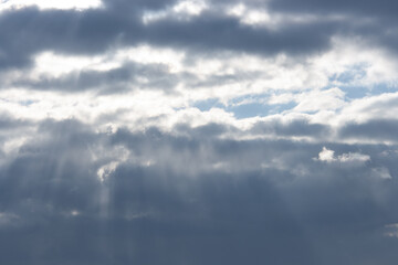 Blue sky behind gray snowy clouds