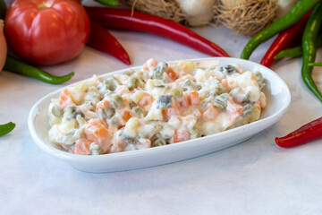 American salad. An aparatif meal prepared with potatoes, peas, pickles, corn and yogurt. Snack meal served alongside the main course. Natural vegetarian food. American salad mezze