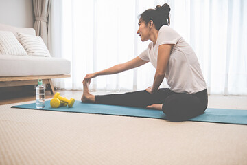 Training at Home. Sporty woman doing yoga plank while watching online tutorial on laptop exercising...