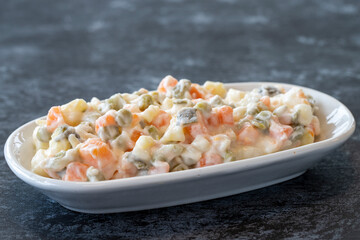 American salad. An aparatif meal prepared with potatoes, peas, pickles, corn and yogurt. Snack meal served alongside the main course. Natural vegetarian food. American salad mezze