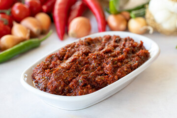 Spicy pastry appetizer (harissa) made with tomato, pepper, garlic, onion, pepper paste and olive oil. Traditional Middle Eastern cuisine flavors. Acılı ezme. adjika