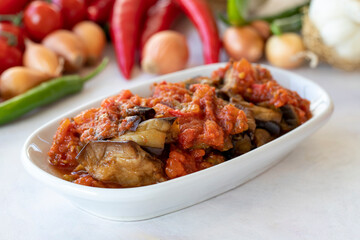 Fototapeta premium Grilled eggplant salad appetizer with tomato sauce (with eggplant sauce or saksuka). Traditional Middle Eastern meze beside the main course.