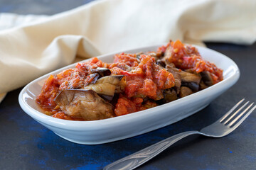 Grilled eggplant salad appetizer with tomato sauce (with eggplant sauce or saksuka). Traditional Middle Eastern meze beside the main course.