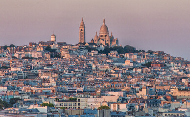 Aerial view of Paris cityscape with Basilica of the Sacred Heart of Paris (Basilique du Sacre Coeur) on Montmartre hill from the top of Triumphal Arch of the Star 