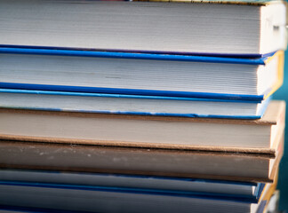 a stack of books and glasses are on the table