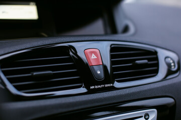 Fototapeta na wymiar Ventilation vents with air flow deflectors and car emergency lights button.