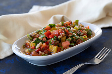 Healthy vegetarian food, traditional flavor Gavurdagi Salad with walnut. coban or choban salad. Mezze served alongside the main course. Appetizer